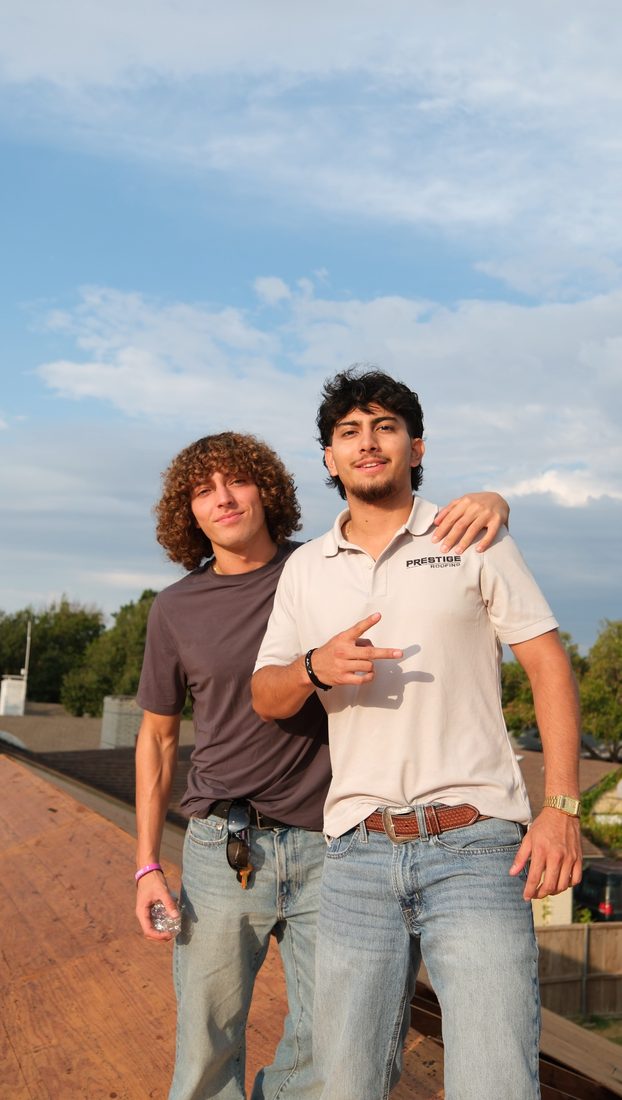 Two Prestige team members on a roof
