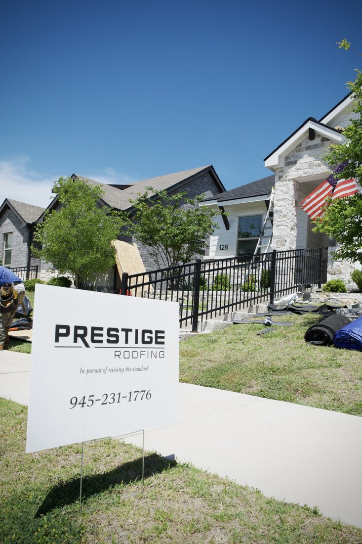 Prestige Roofing yard sign at a finished home